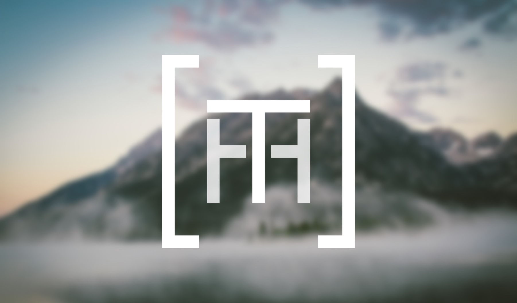 Tyler Hendrickson logo in front of a mountain